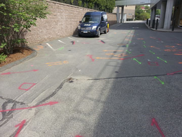 A small driveway with orange and red markings.