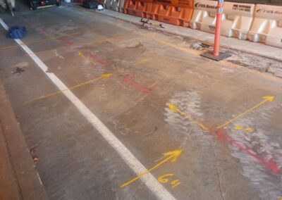 An empty driveway with white and orange markings.