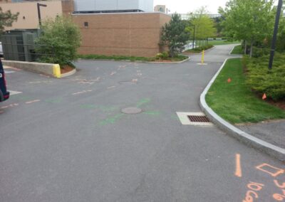 An empty driveway with orange markings.