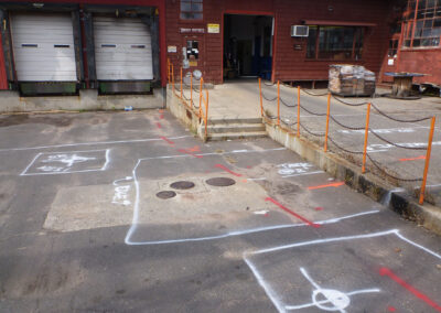 An empty industrial space with white markings on the ground.