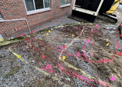 Orange arrow markings behind a brown bricked building.