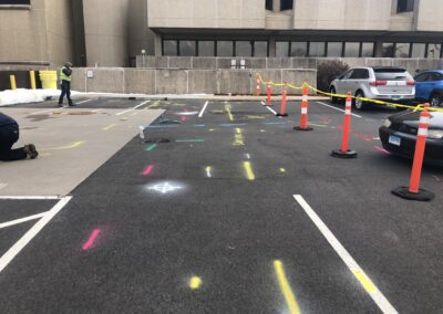 A barricaded parking lot with orange and blue markings on the ground.