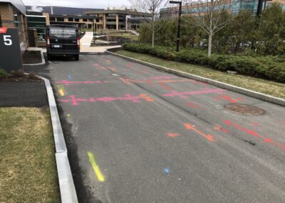 A driveway with orange markings on the ground.