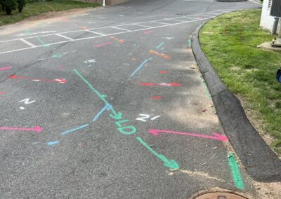 A driveway with blue and orange markings on the ground.