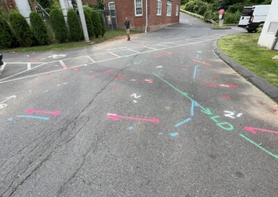 A driveway with blue and orange markings on the ground.