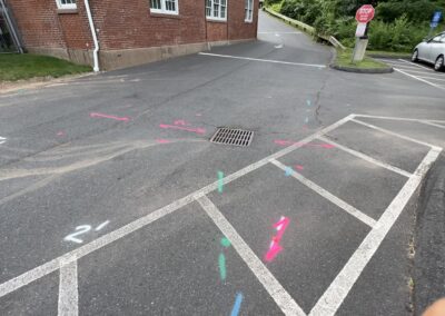 A driveway with blue and orange markings on the ground.